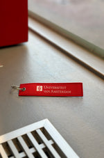 Keychain with the University of Amsterdam logo